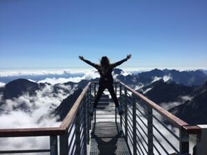 woman stood holding arms up high