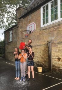 3 young car washers getting soaked